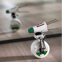 a toy rocket sitting on a wooden floor