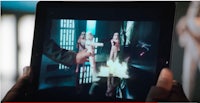a person is holding an ipad with a star wars image on it