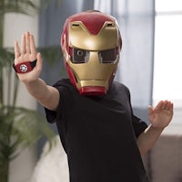 a child wearing an iron man mask in a living room