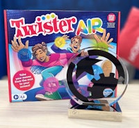 the twister air game is on a table next to a trophy