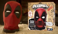 a deadpool mask with a box next to it