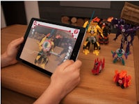 a child is playing with toys on an ipad